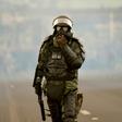 A soldier takes up position during clashes with indigenous people and farmers protesting against fuel hikes introduced by Ecuador's President Lenin Moreno, on the outskirts of Quito