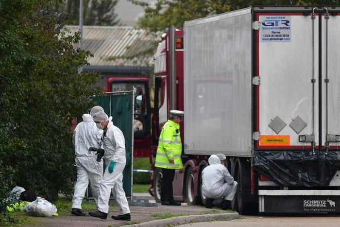 British Police forensics officers work on lorry, found to be containing 39 dead bodies, at Waterglade Industrial Park in Grays, east of LondonindusTrial park in Grays, east of London
