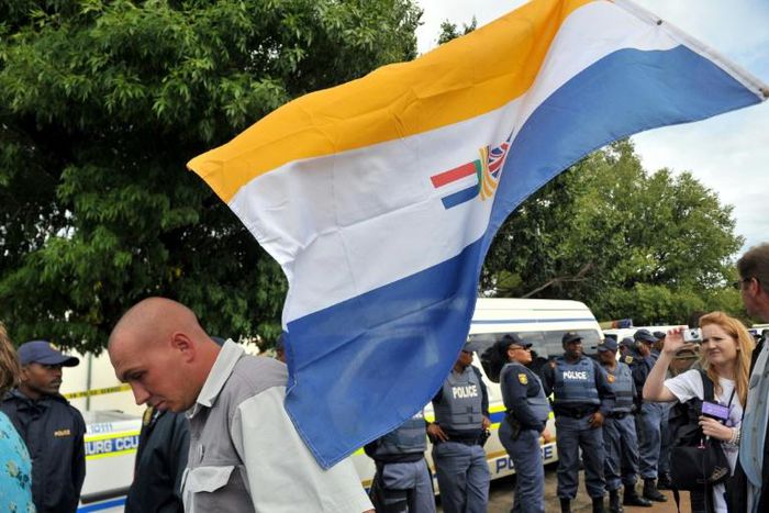 April 2010: White supremacists brandish the apartheid-era flag outside a court in Ventersdorp ahead of the trial of two men accused of killing far-right leader Eugene Terre'Blanche