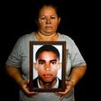 Luz Edilia Florez, 57, mother of disappeared Jose Ernesto Moran, poses with a photo of him in Cali, Colombia