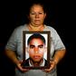 Luz Edilia Florez, 57, mother of disappeared Jose Ernesto Moran, poses with a photo of him in Cali, Colombia