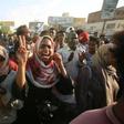 Sudanese demonstrators march during a protest in Khartoum urging the country's new authorities to dissolve the former ruling party of ousted Islamist leader Omar al-Bashir