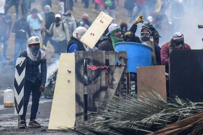 Demonstrators in Ecuador clash with riot police during a protest over a fuel price hike ordered by the government to secure an IMF loan