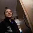 Greta Thunberg wore an oversized black windbreaker emblazoned with the words "Unite Behind The Science" as heavy, freezing rain pounded the hull of the sailboat she is traveling on to Europe