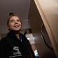 Greta Thunberg wore an oversized black windbreaker emblazoned with the words "Unite Behind The Science" as heavy, freezing rain pounded the hull of the sailboat she is traveling on to Europe