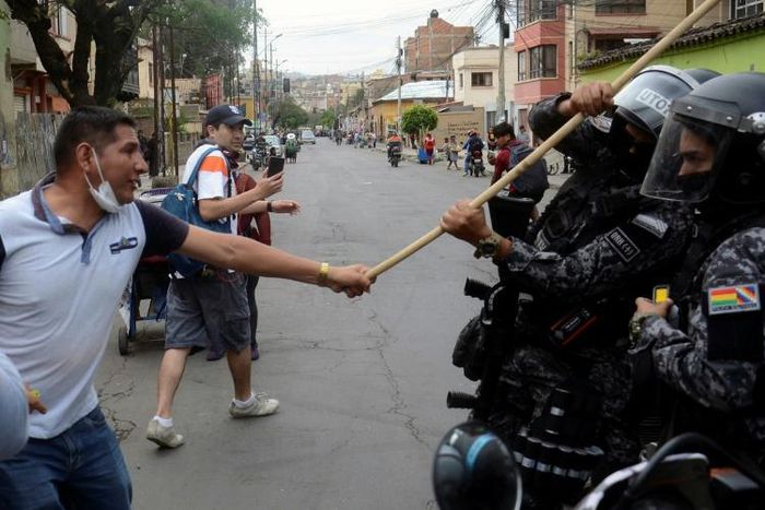 Bolivian pro-government supporters clash with riot police during a rally for President Evo Morales in Cochabamba
