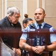 Australian Cardinal George Pell is escorted into the Supreme Court at the start of his appeal against conviction on child sex abuse charges. He will hear the court's decision this week