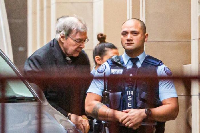Australian Cardinal George Pell is escorted into the Supreme Court at the start of his appeal against conviction on child sex abuse charges. He will hear the court's decision this week