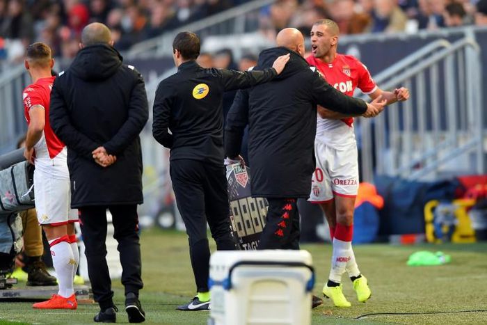 Monaco's Islam Slimani had to restrained after being shown a red card in Bordeaux. The Algerian scored but then conceded the decisive penalty
