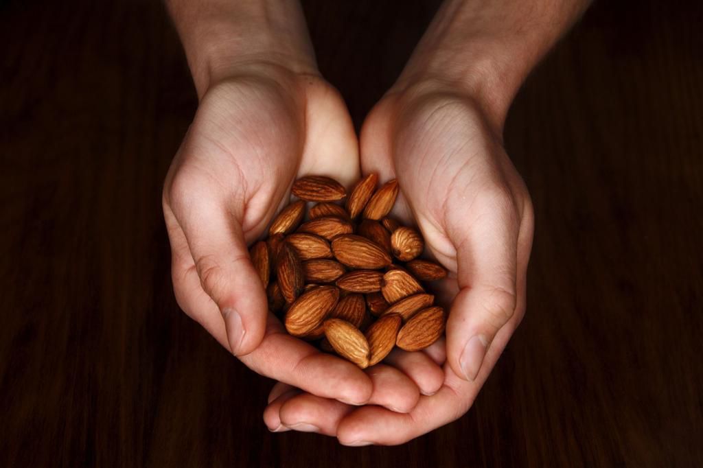 Cropped Hands Holding Almonds