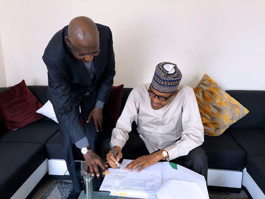 President Muhammadu Buhari signs Deep Offshore bill into law in London, with Chief of Staff Abba Kyari (Twitter: @BashirAhmaad)