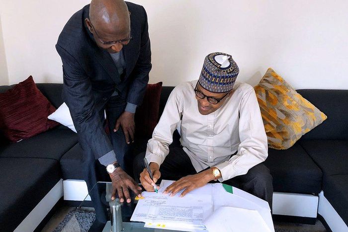 President Muhammadu Buhari signs Deep Offshore bill into law in London, with Chief of Staff Abba Kyari (Twitter: @BashirAhmaad)