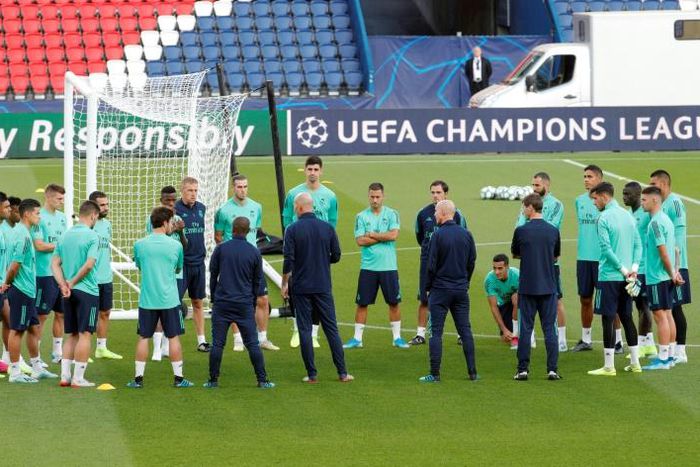 Real Madrid coach Zinedine Zidane talks to his players on the Parc des Princes pitch ahead of Wednesday's Champions League clash with Paris Saint-Germain