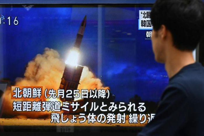 A pedestrian in Tokyo watches a television report on the latest North Korean launch