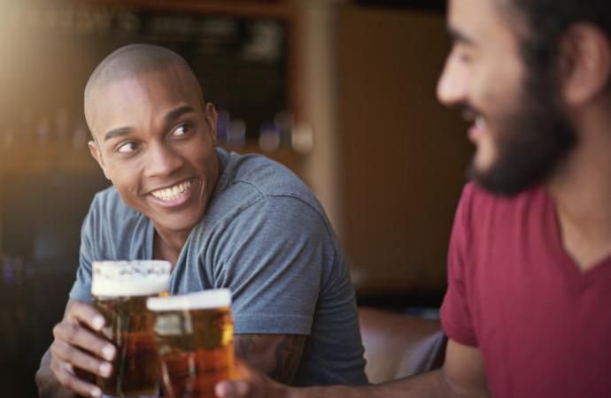 Men sharing a drink [Credit - Alternative News]