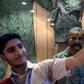 A Pakistan student in Karachi takes a selfie in front of the statue of Indian pilot Wing Commander Abhinandan Varthaman who was shot down over Kashmir earlier this year