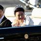 Japan’s Emperor Naruhito  and Empress Masako wave during their royal parade in Tokyo