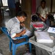 Workers from the National Register of Citizens check documents ahead of the release of the register's final draft in Guwahati, the capital of India Assam state