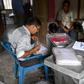 Workers from the National Register of Citizens check documents ahead of the release of the register's final draft in Guwahati, the capital of India Assam state