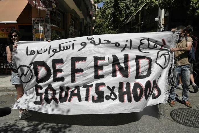 The protest came weeks after the new conservative government sent police to clear out four building squats in the bohemian Athens district of Exarchia, removing 143 migrants who had found shelter there