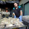 Queensland police officer arranges packets containing drugs after authorities seized 766 kilograms (1,670 pounds) of the "highest purity" MDMA recorded in Queensland state