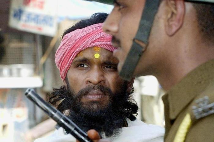 For decades Hindus and Muslims have been bitterly divided over the 16th-century Babri mosque - here a sadhu, a Hindu holy man, is stopped from entering the disputed site in March 2002