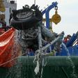 An Indonesian rescue team is seen lifting a pairof tires from the ill-fated Lion Air flight JT 610 off Karawang in the Java Sea a few days after the October 29, 2018 crash