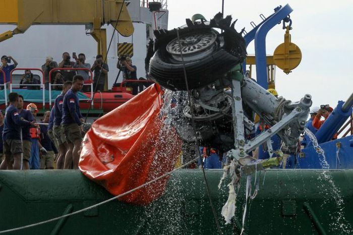 An Indonesian rescue team is seen lifting a pairof tires from the ill-fated Lion Air flight JT 610 off Karawang in the Java Sea a few days after the October 29, 2018 crash
