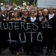 Women dressed in black march to the presidential palace in Santiago demanding justice for those killed and injured during two weeks of protests
