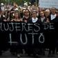 Women dressed in black march to the presidential palace in Santiago demanding justice for those killed and injured during two weeks of protests