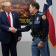 US President Donald Trump shakes hands with El Paso Police Chief Greg Allen (R) before greeting first responders in the wake of the massacre of 22 people at a local Walmart