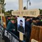 Forest guards stand next to wooden crosses bearing the names of their killed colleagues during a protest near the Romanian Parliament building in Bucharest