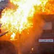 A riot police vehicle burns in Tayeran Square in the heart of Baghdad on Thursday as protests escalate in the capital and across the south