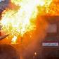 A riot police vehicle burns in Tayeran Square in the heart of Baghdad on Thursday as protests escalate in the capital and across the south