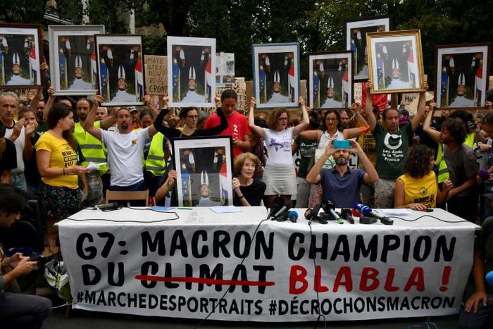 Demonstrators at the so-called "portrait march" were carrying official portraits of the 41-year-old French leader