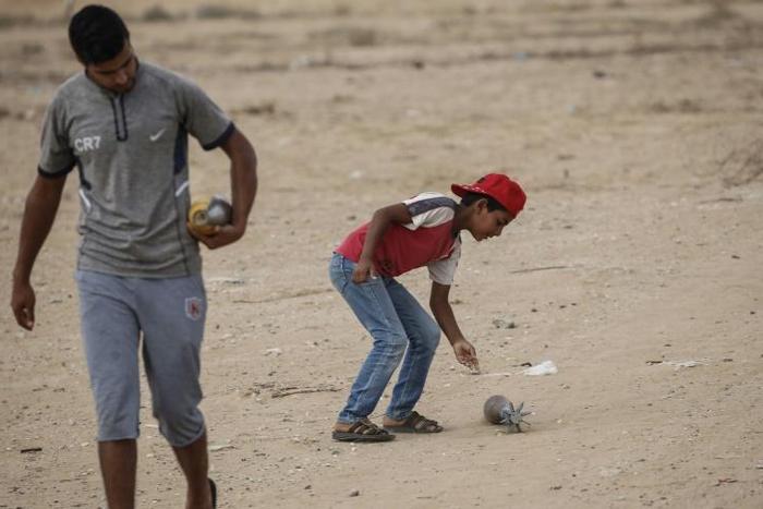 Israel has warned the Gaza Strip's residents and its Hamas rulers that further attacks on Israel could incur tougher conditions for the coastal territory; Palestinian boys carry mortar shells next to a Hamas military post August 1, 2019
