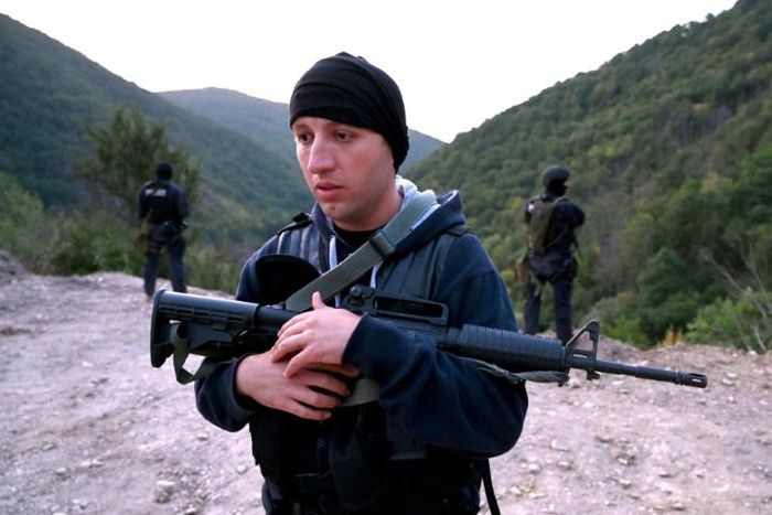 A Georgian special police officer patrols with colleagues the Georgian-South Ossetian border at a check point in the Kvemo Kartli region some 120 km outside Tbilisi on August 30, 2019