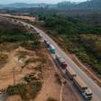 An aerial view of trucks queueing on the BR163 in Brazil's Para state -- one of two major transport routes that have played a key role in the development and destruction of the Amazon, the world's largest rainforest