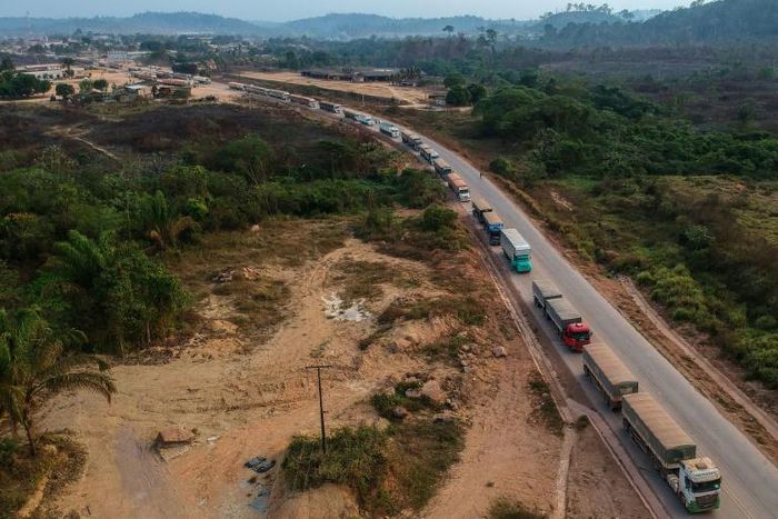An aerial view of trucks queueing on the BR163 in Brazil's Para state -- one of two major transport routes that have played a key role in the development and destruction of the Amazon, the world's largest rainforest
