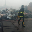 A Lagos State firefighter at scene of the incident [Punch]