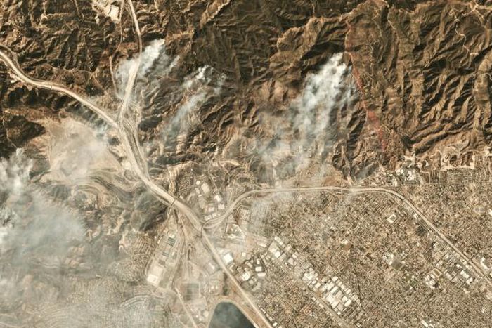 Smoke from the Saddleridge fire about 20 miles north of downtown Los Angeles is seen in this image from Planet Labs Inc