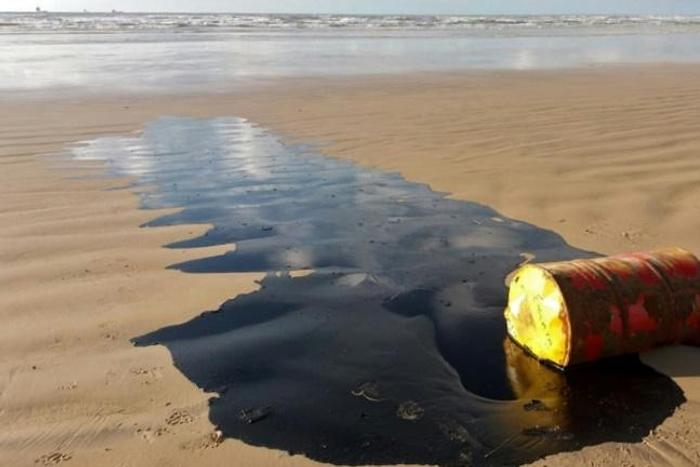 A barrel of oil leaking on a beach in Barra dos Coqueiros, in the Braziilian state of Sergipe