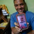 Venezuelan Frankeiber Hernandez, 18, whose parents emigrated to Peru, shows a picture of his mother on his mobile phone at home in the Catia neighborhood in Caracas