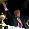 Mexican President Andres Manuel Lopez Obrador waves from the balcony of the National Palace during the anniversary of the Mexican Revolution in Mexico City on November 20