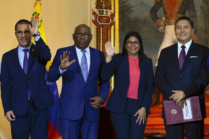 Venezuelan Foreign Minister Jorge Arreaza, Education Minister Aristobulo Isturiz, Vice President Delcy Rodriguez and opposition member Javier Bertucci pose after signing a dialogue agreement between the government and the opposition in Caracas