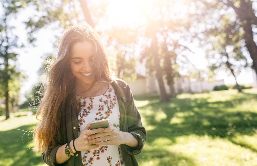 Young woman sending messages with her smartphone