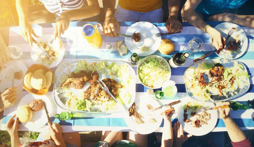 Group of people having lunch outdoors.