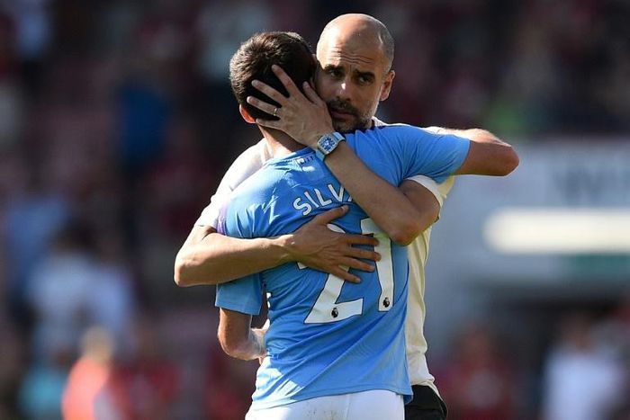 Manchester City manager Pep Guardiola embraces Spanish midfielder David Silva