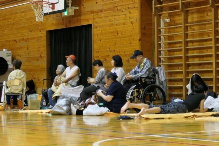Evacuated residents siting inside a shelter in Tokyo to wait out Typhoon Hagibis