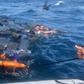 A photo released by the Colombian Navy on October 1, 2019 shows the rescue of three men floating on bales of cocaine off the Pacific coast